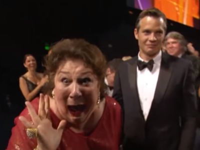 Margo Martindale is looking at the camera while Timothy Olyphant is looking at something else.